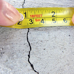 A crack in a poured concrete wall that's showing a normal crack during curing in Cheshire